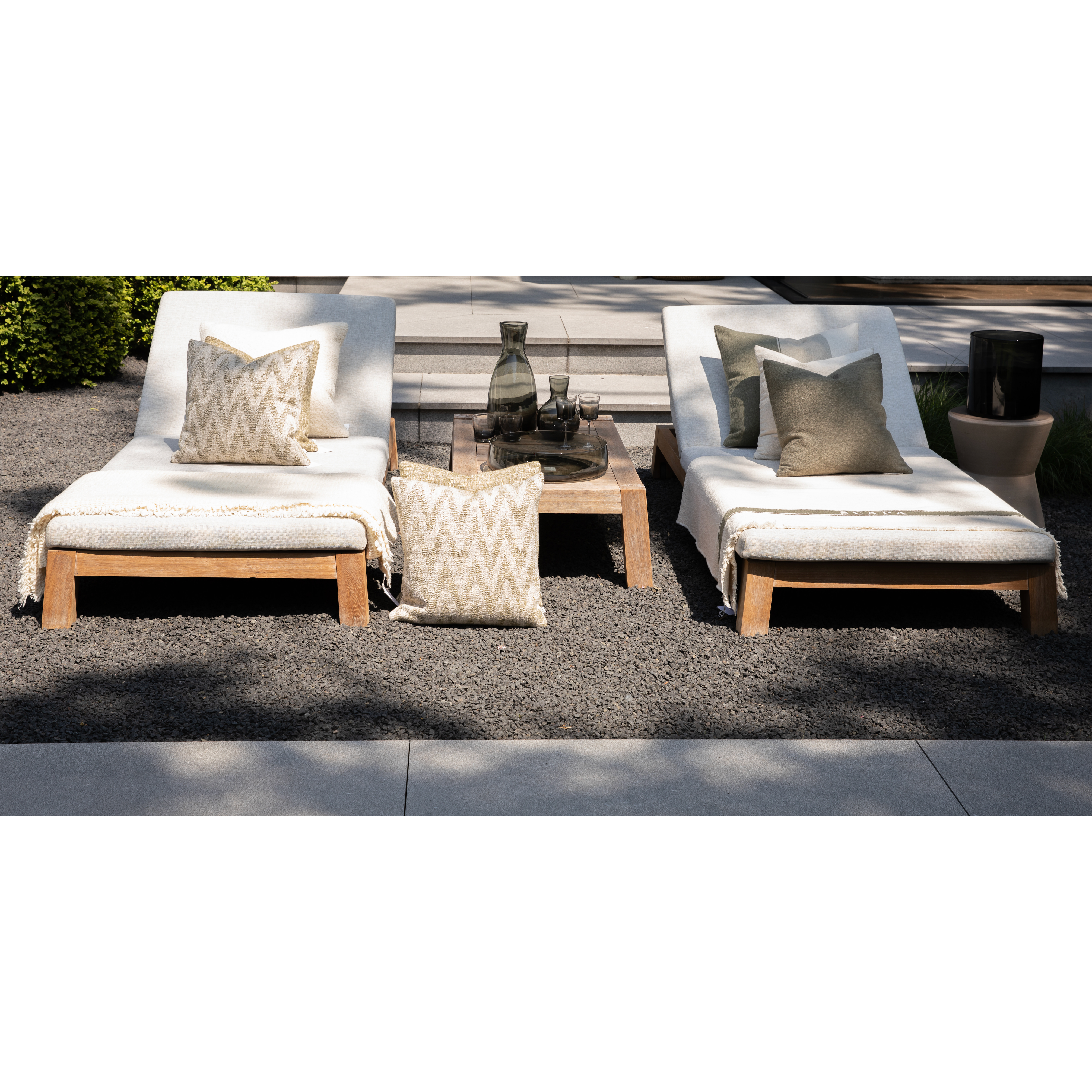 Scapa_Home_grey_glass_accessoiries_on_sunbeds_garden_setting_front_view