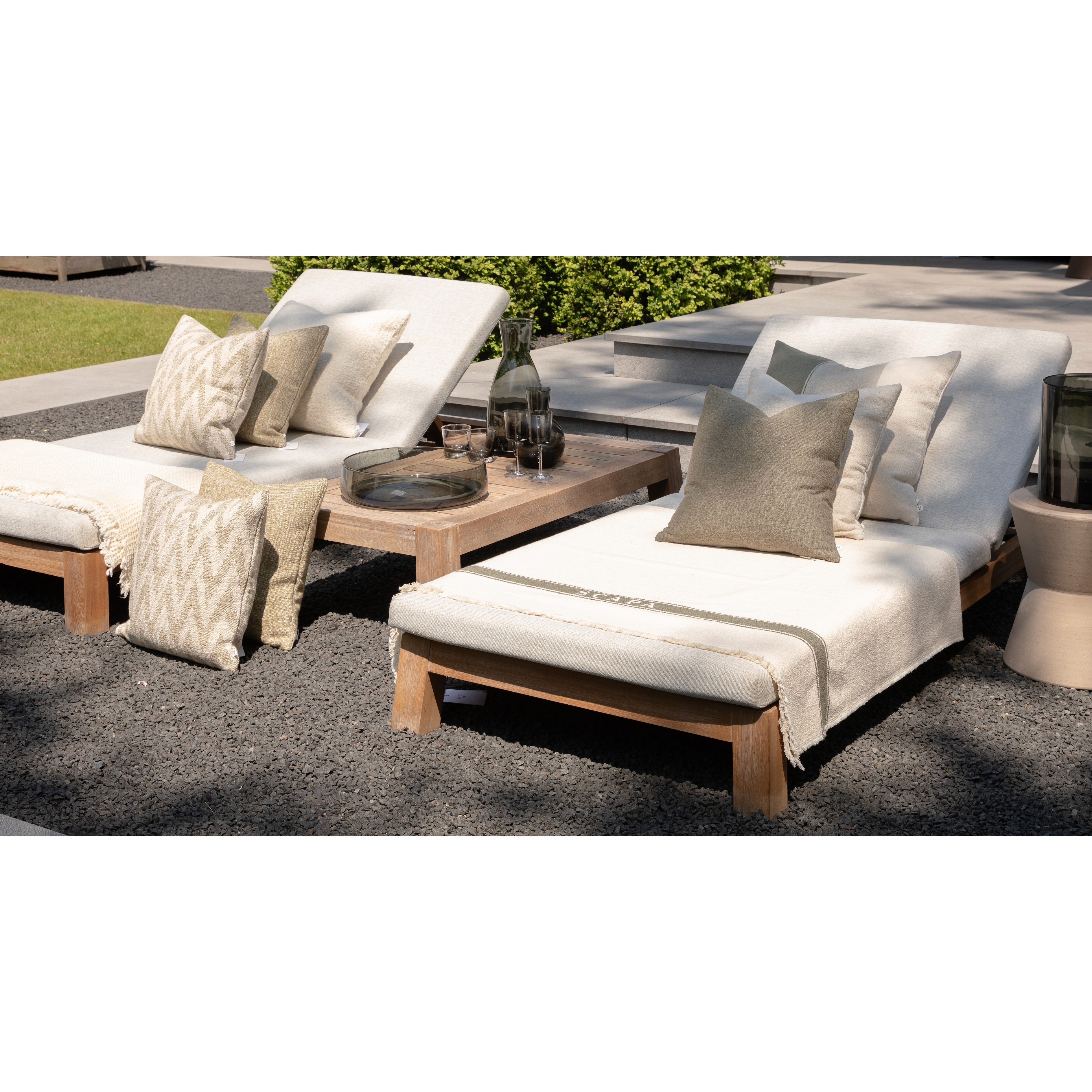 Scapa_Home_grey_glass_accessoiries_on_sunbeds_garden_setting_front_view